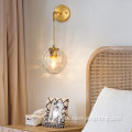Copper wall lamp with suspended grain glass ball